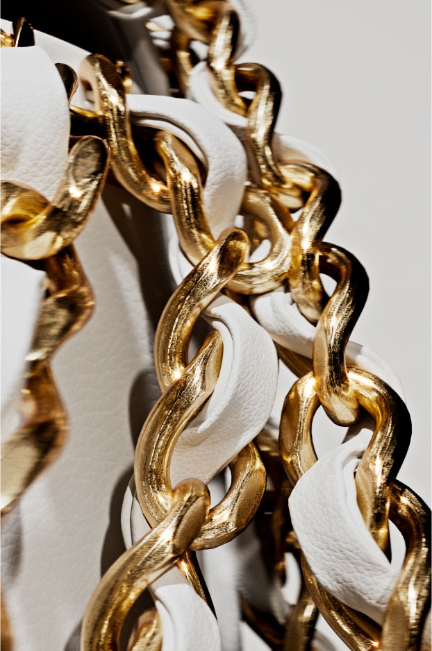 coco chanel photorealistic cgi closeup of gold metal chain on luxury brand bag